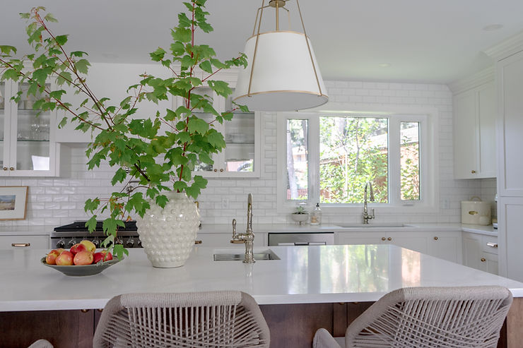 transitional cream kitchen with plaster hood fan glass cabinetry