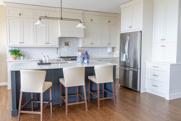 Transitional cream kitchen with navy island, modern island light