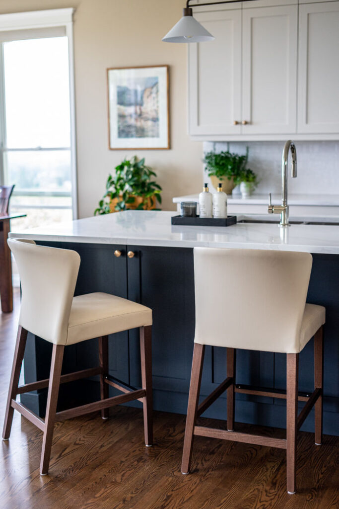Transitional cream kitchen with navy island,