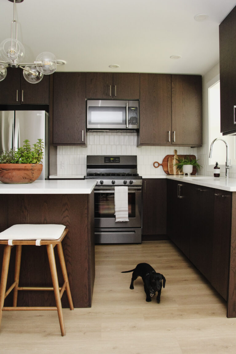 MCM basement suite kitchen, walnut veneer cabinets, quartz, vertical subway tile backsplash, with puppy