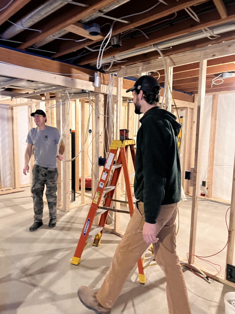 2 contractors working on an unfinished basement