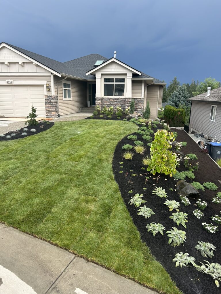 Landscaped front yard with pretty craftsman house
