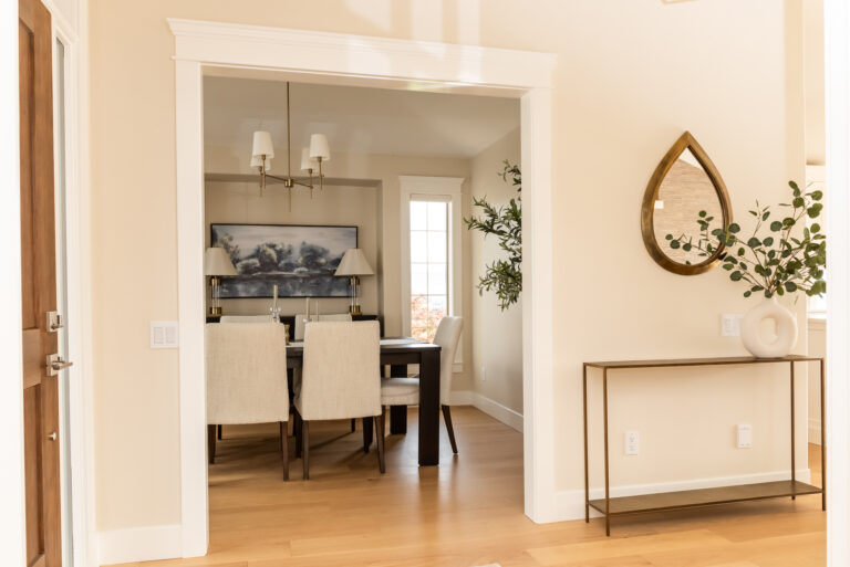 Transitional Dining room off entry, warm white