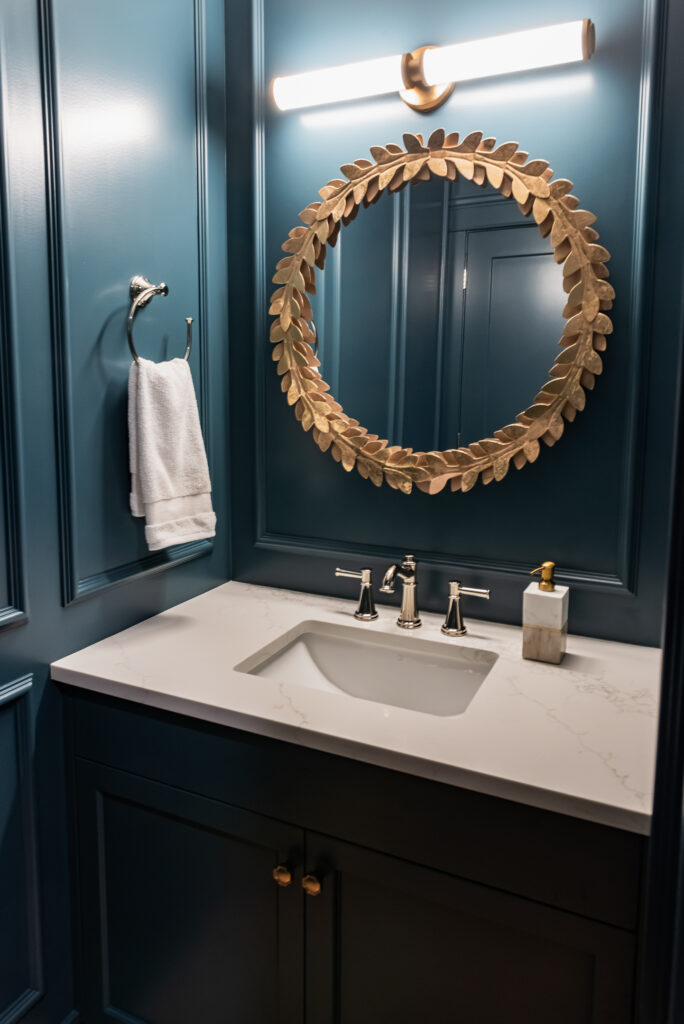 Moody colour drench Blue Powder Room with picture frame moulding