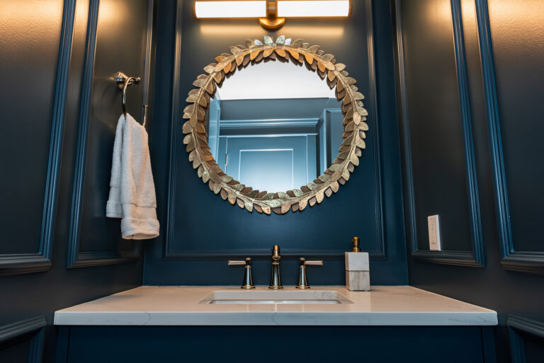 Moody colour drench Blue Powder Room with picture frame moulding