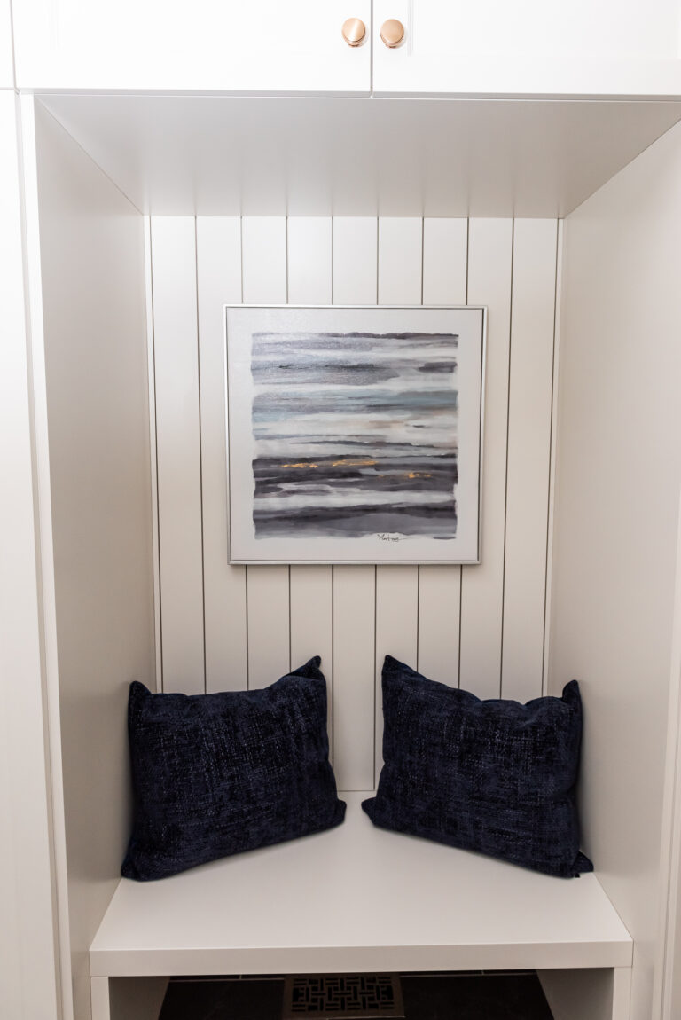 Cream mudroom cabinetry shiplap seating nook