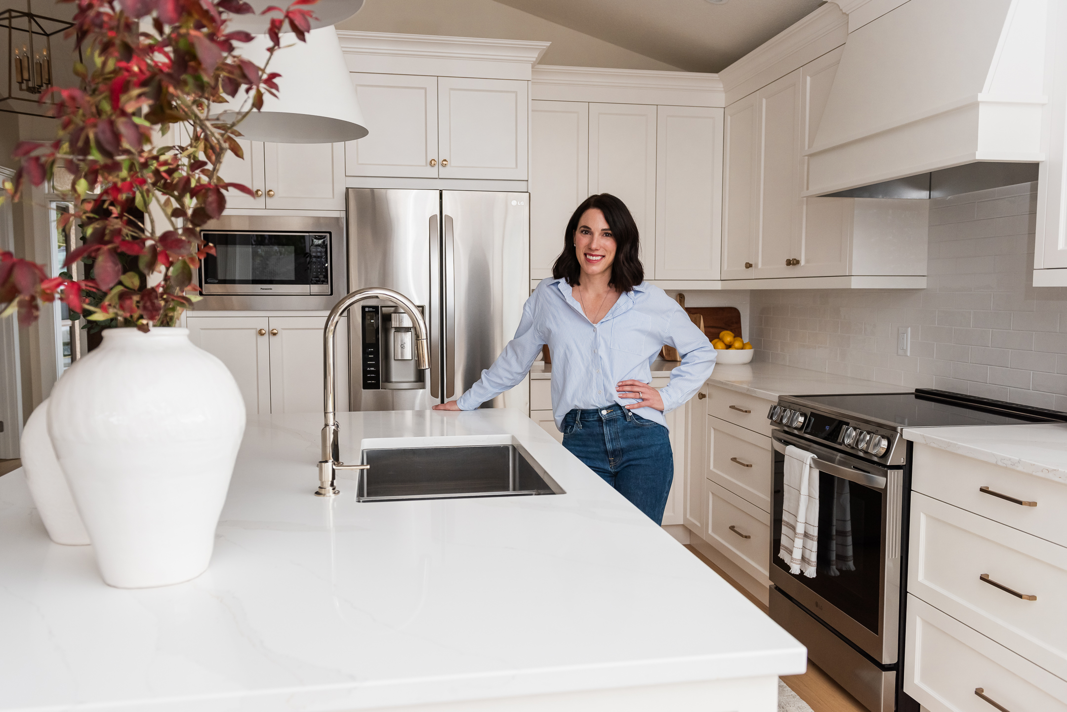 Interior Designer standing in white kitchen