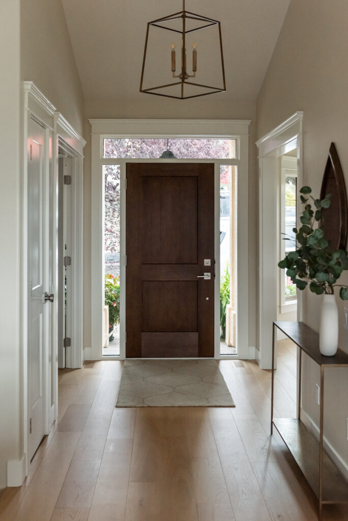 Transitional Entryway with medium wood stain door and transom window