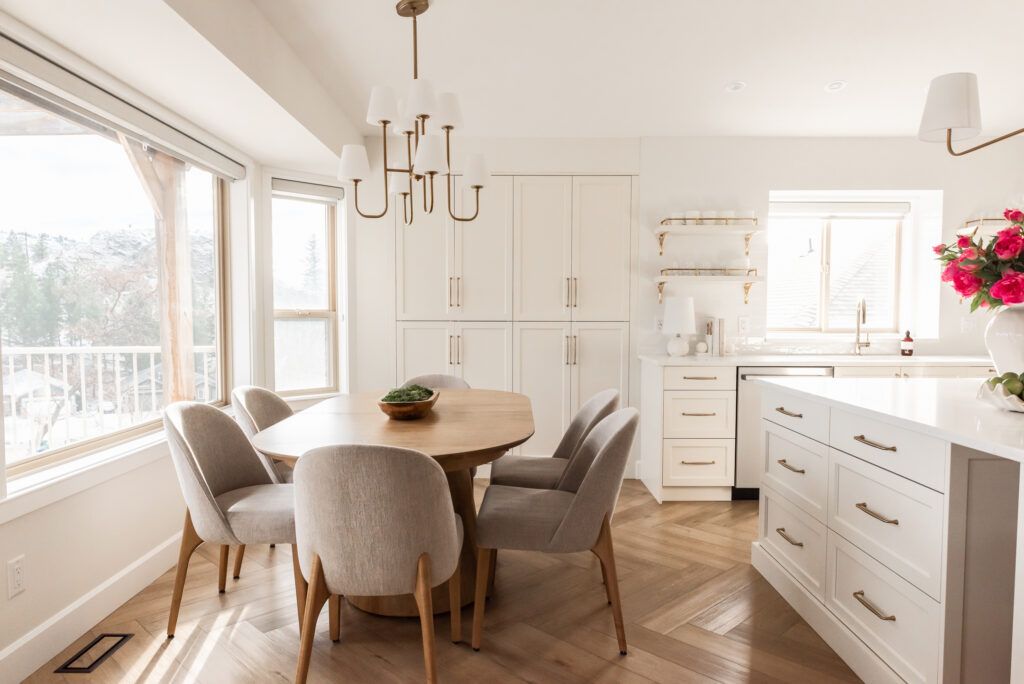 transitional cream kitchen, dining table, open brass shelves, tile to ceiling