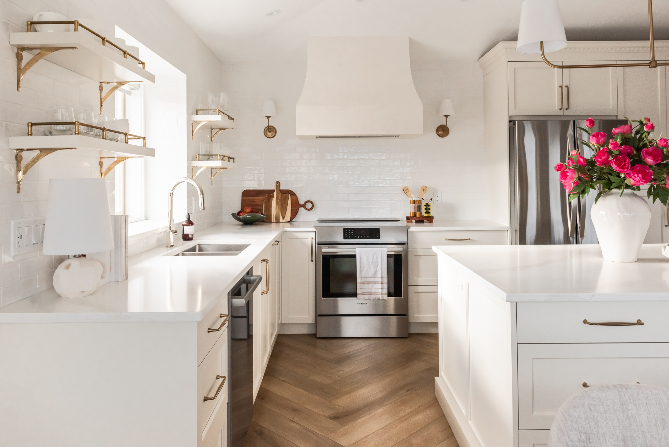 transitional cream kitchen, plaster hood, open brass shelves, tile to ceiling, herringbone floor
