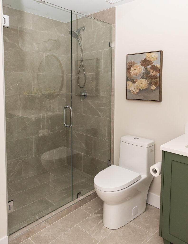basement bathroom with green vanity and walk in shower