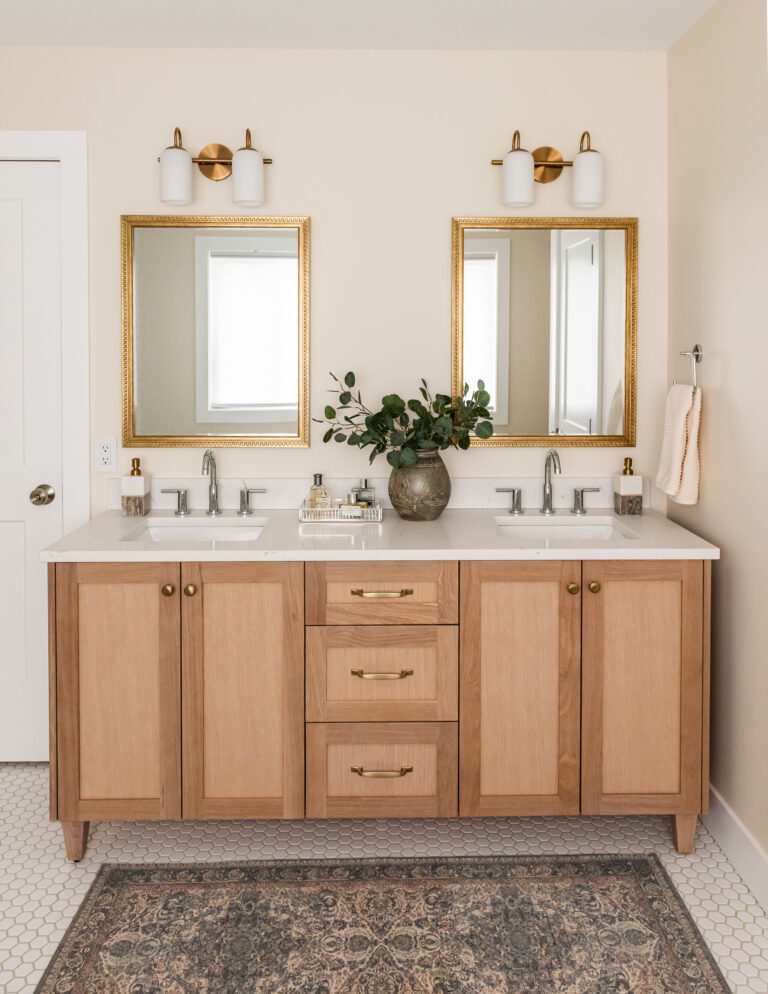 transitional ensuite with white oak vanity, vintage mirrors and styling