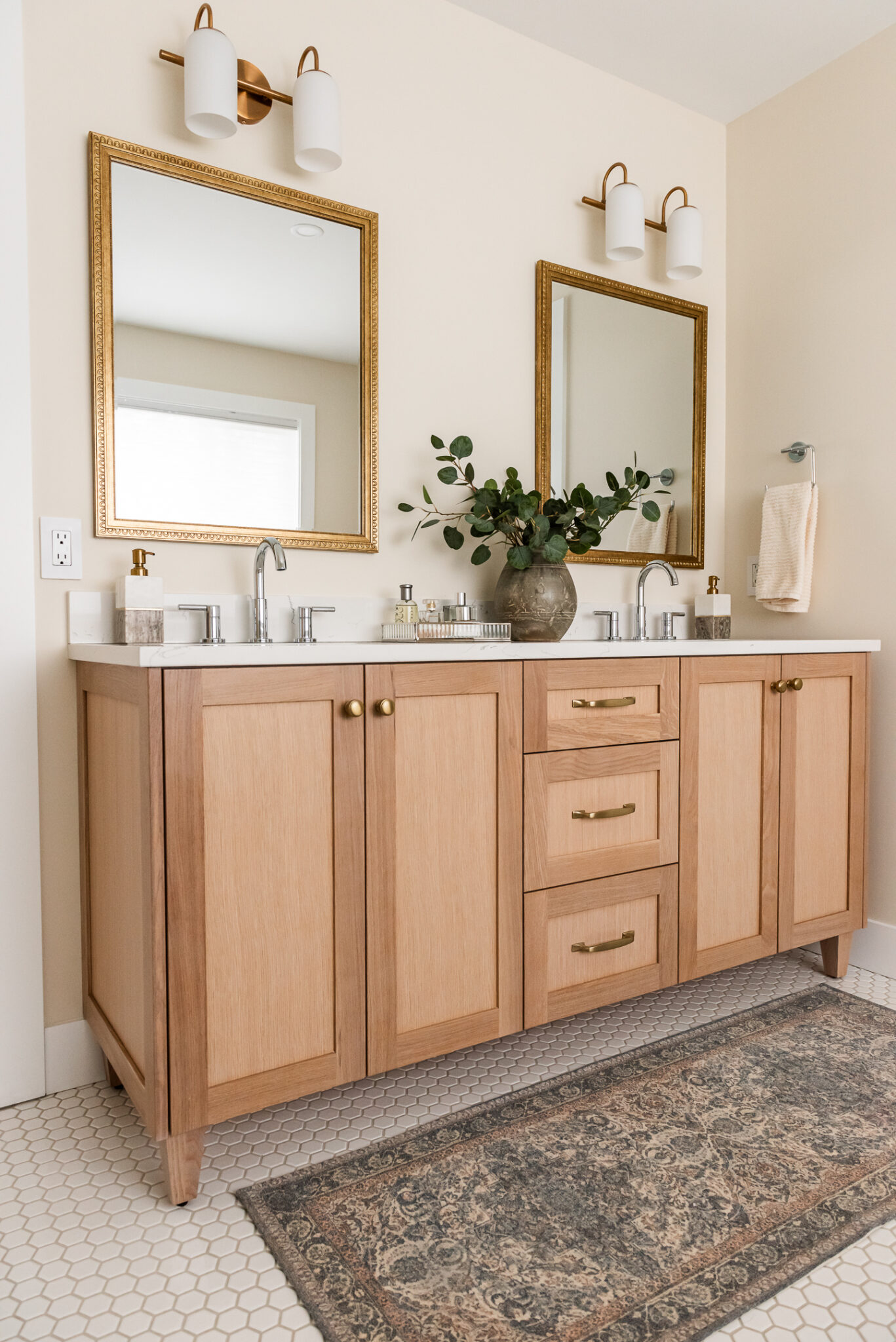 transitional ensuite with white oak vanity, vintage mirrors and styling