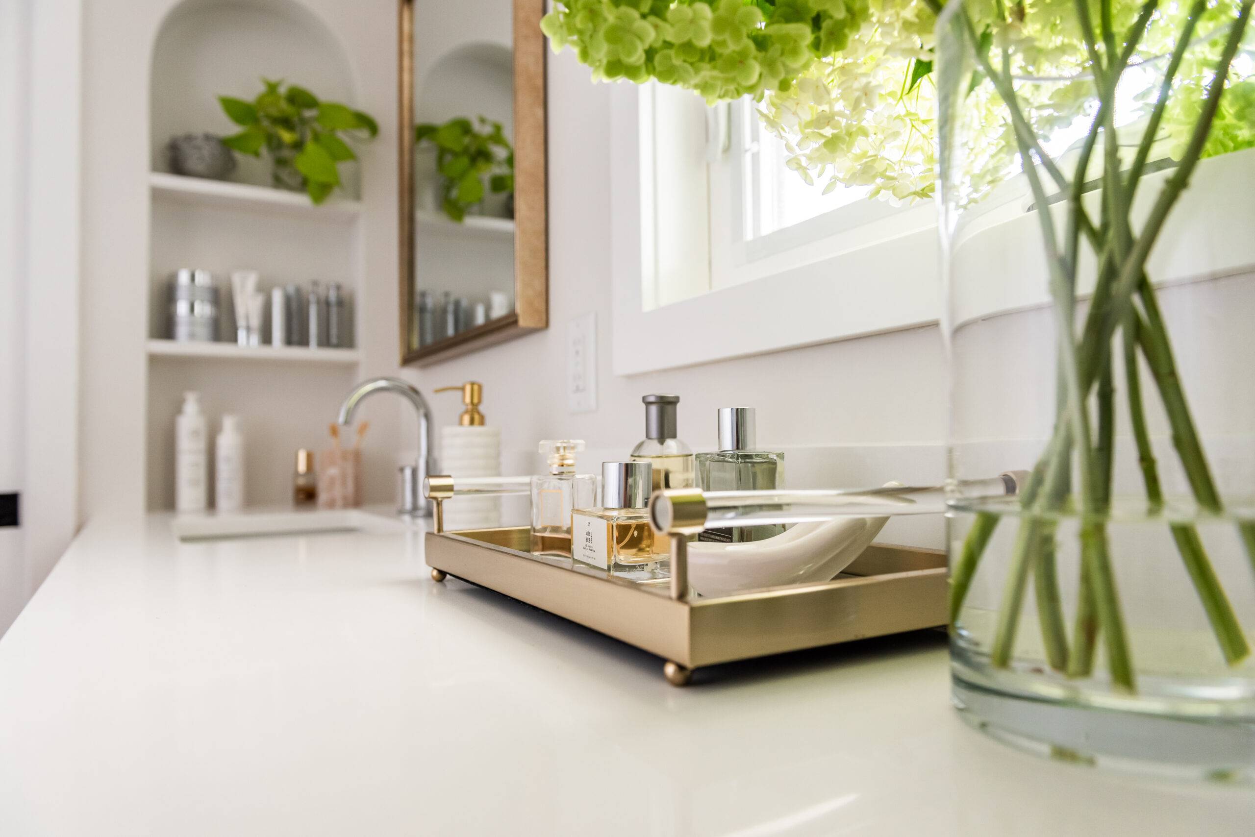 perfume tray in a bathroom with flowers
