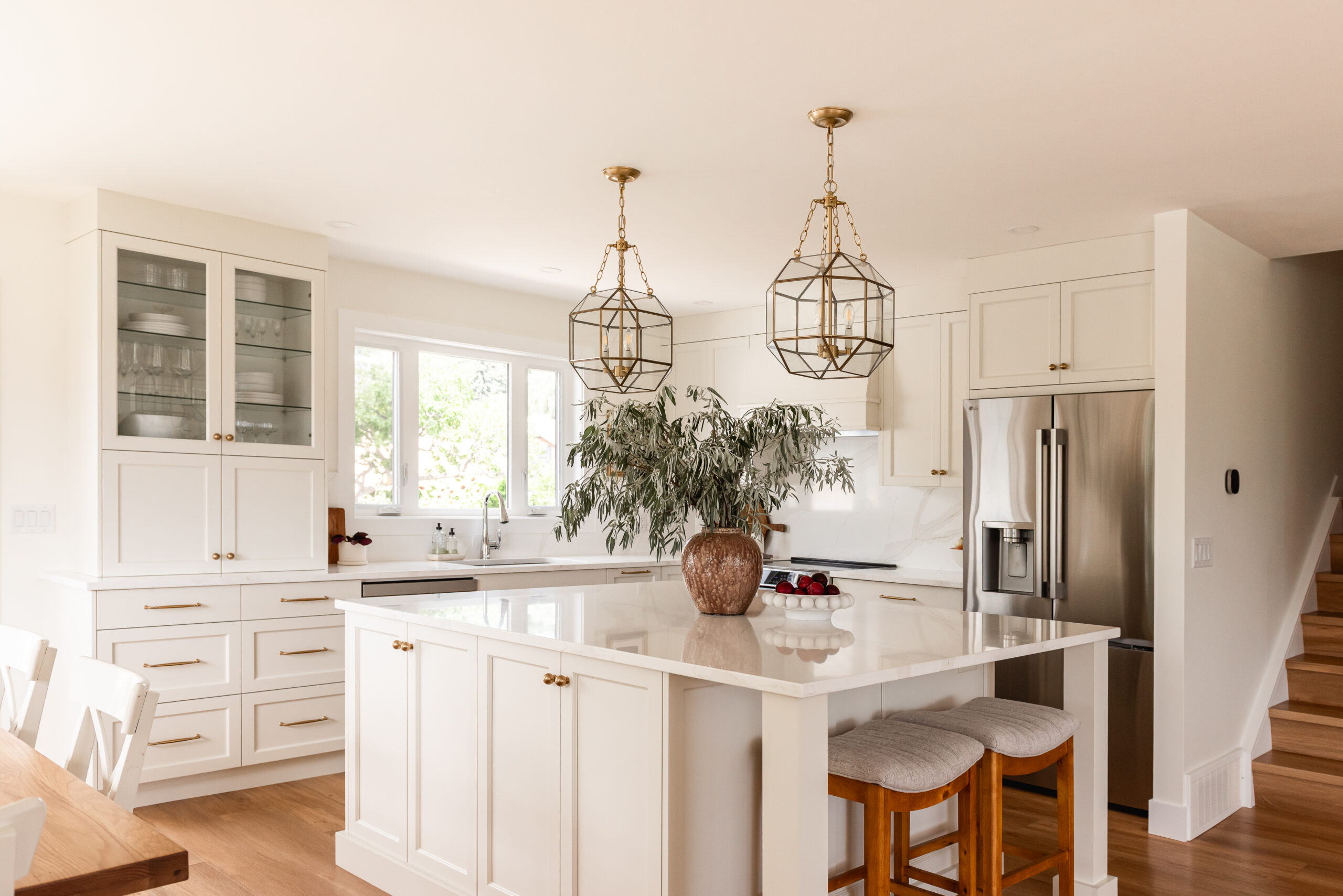 cream kitchen, glass and brass pendants, quartz backsplash, appliance garage