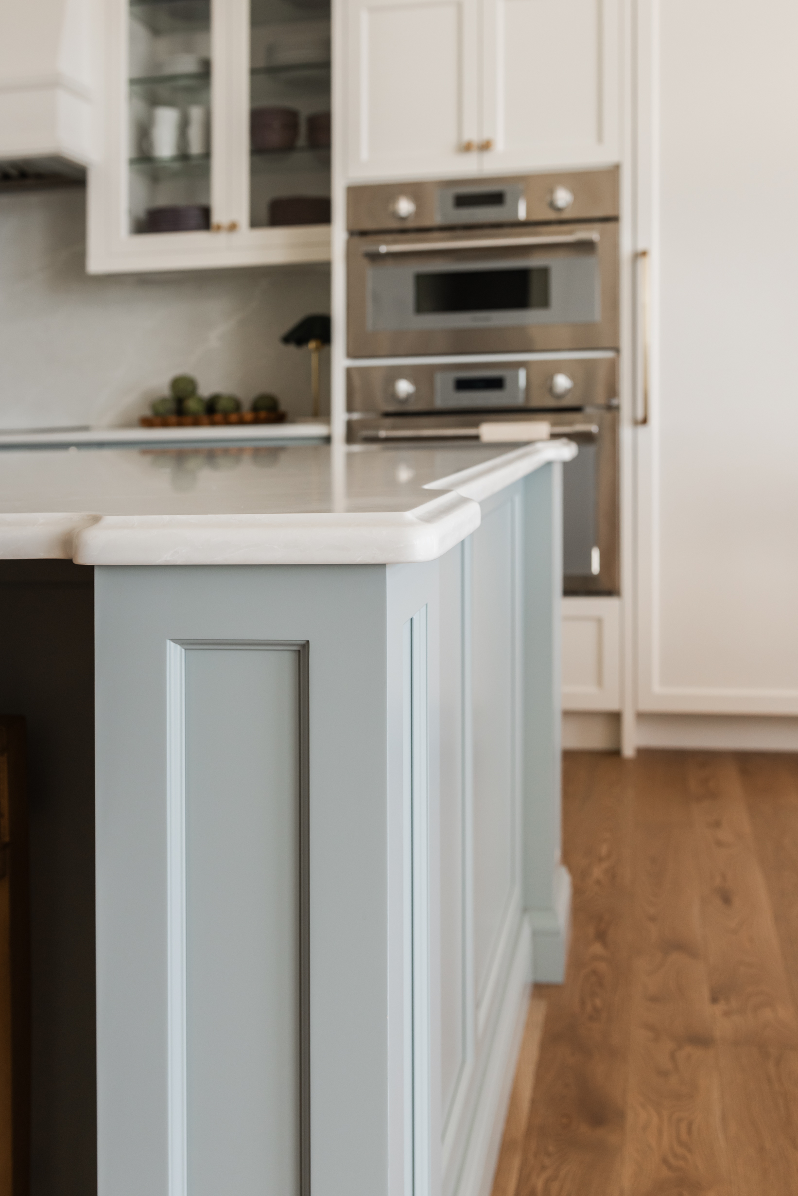 Integrated Thermador appliances, polished nickel bridge faucet and a spacious entertaining island with ogee edge wrapping posts.
