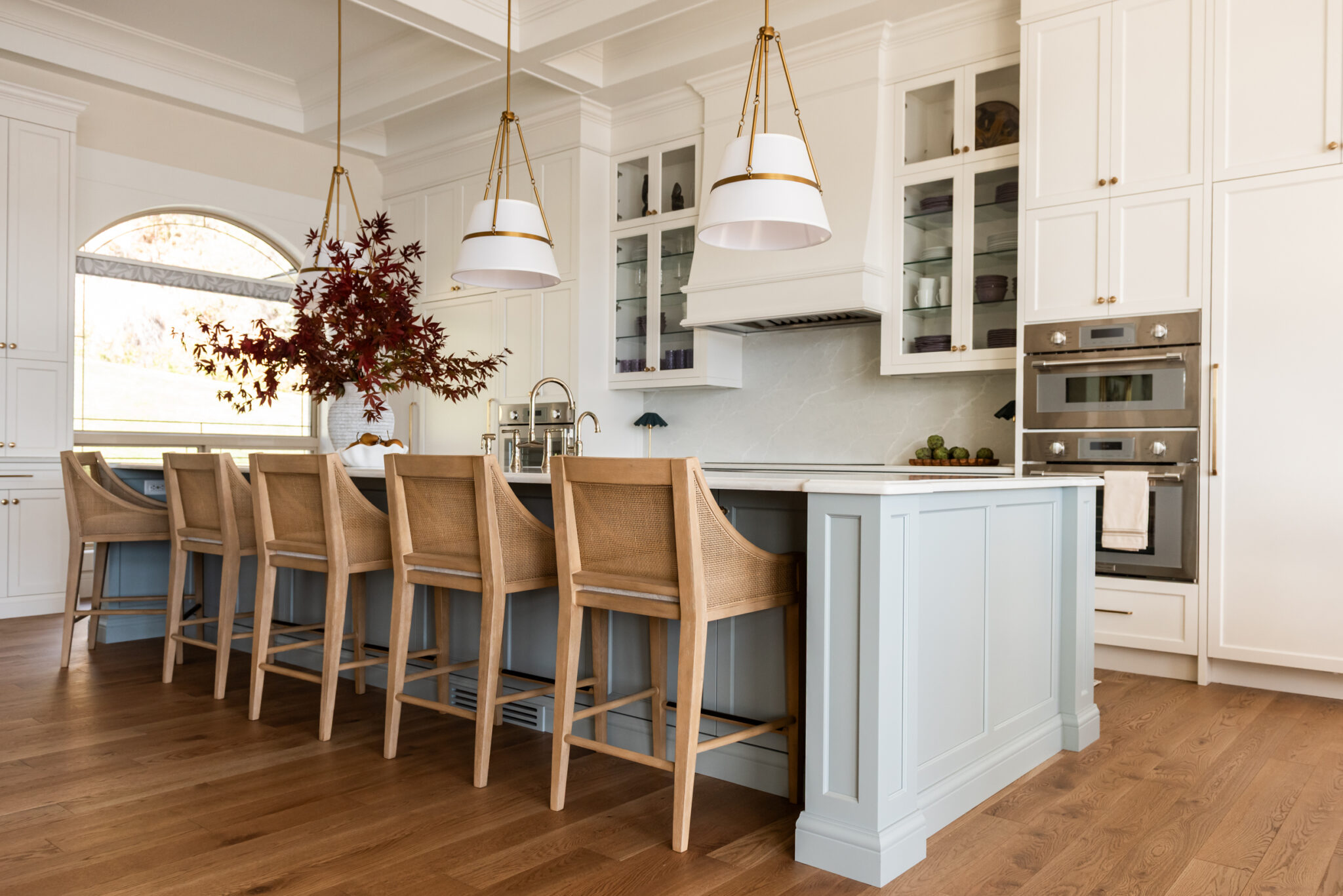 Custom 6-foot range hood feature wall with integrated Thermador appliances, coffered ceilings, polished nickel bridge faucet and a spacious entertaining island.