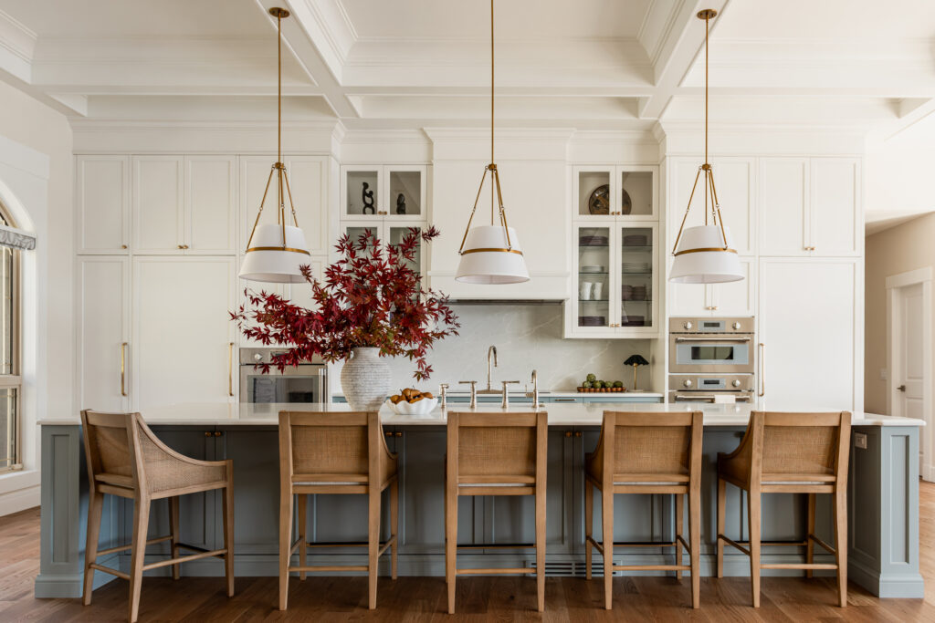 Custom 6-foot range hood feature wall with integrated Thermador appliances, coffered ceilings, polished nickel bridge faucet and a spacious entertaining island.