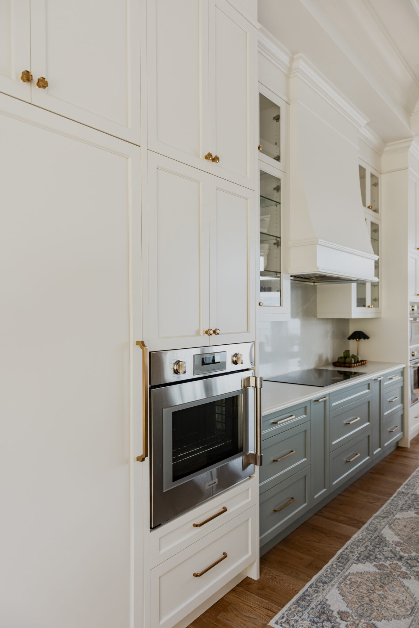 Range hood feature wall with integrated Thermador appliances, coffered ceilings