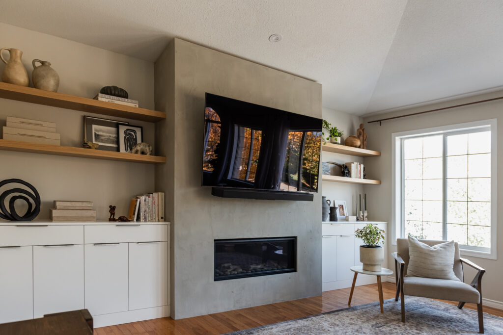 Modern living room with zero clearance fireplace, hand plastered surround, white oak floating shelves, and custom built in cabinetry for concealed storage.