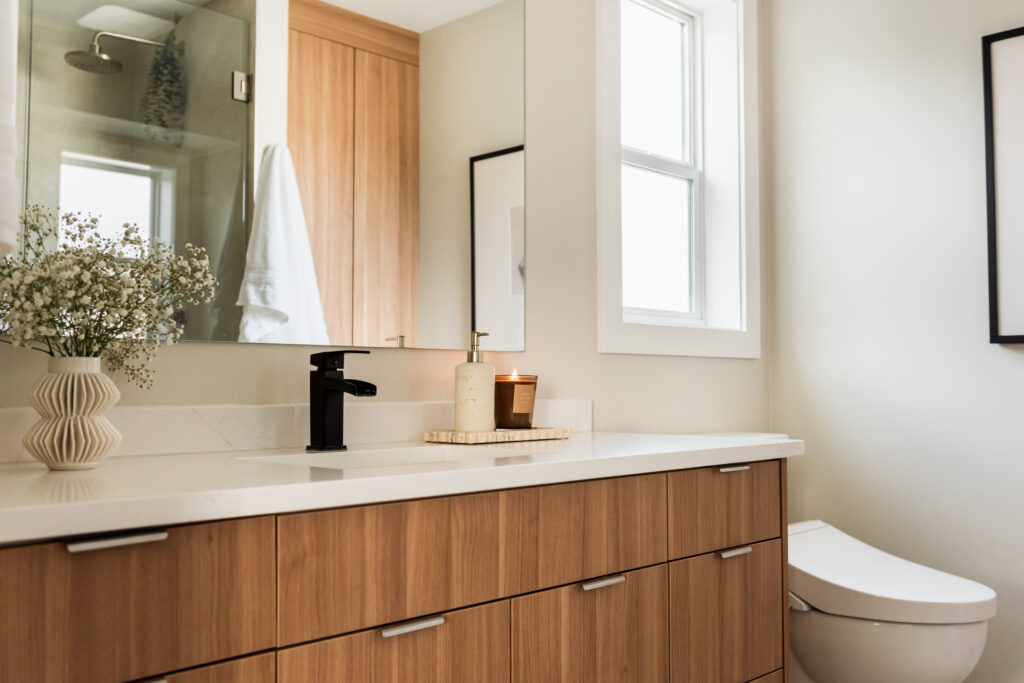 Ensuite bathroom featuring large tiled walk in shower with built in bench, oversized niche, and rainfall shower head.