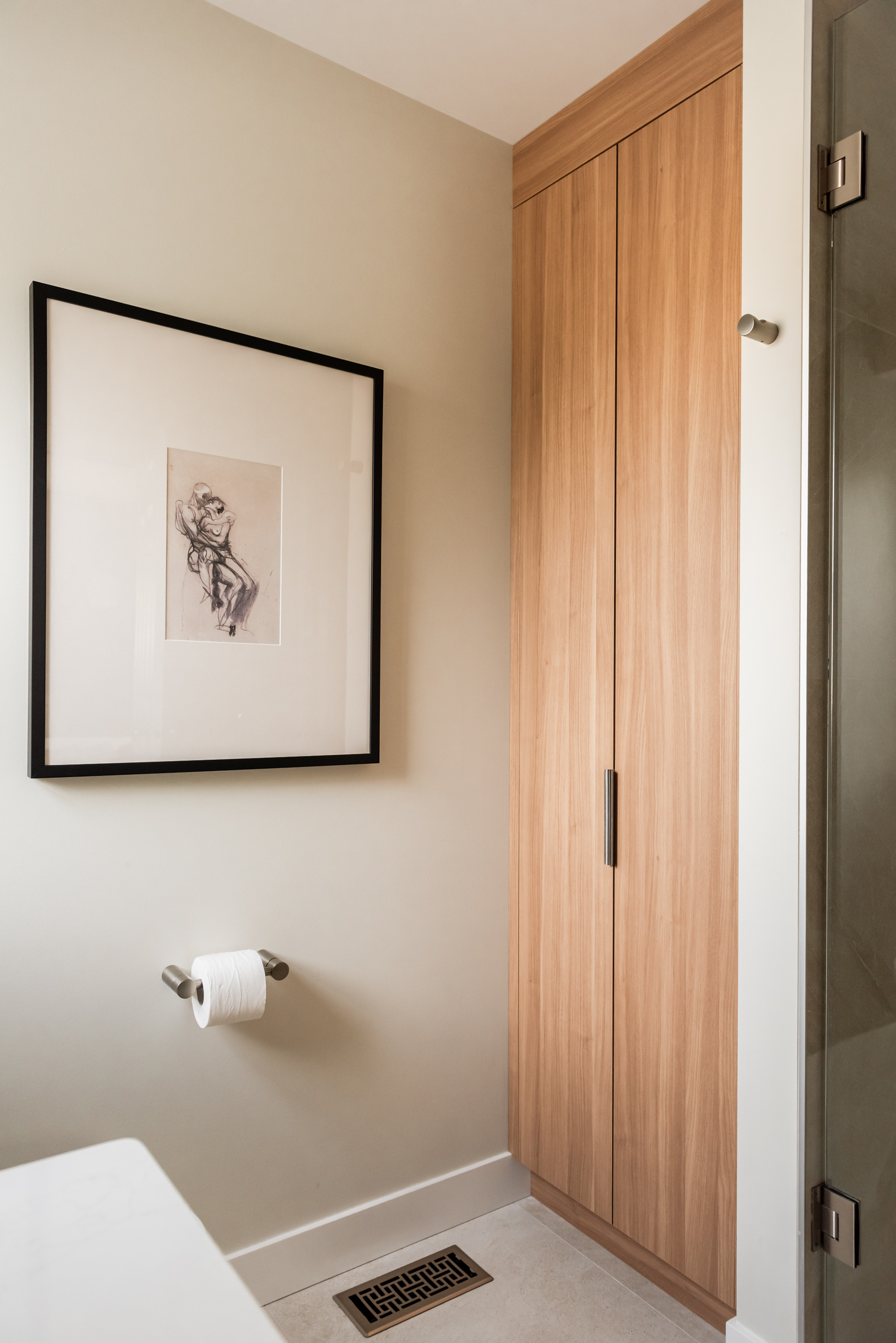 Ensuite bathroom featuring large tiled walk in shower with built in bench, oversized niche, and rainfall shower head.