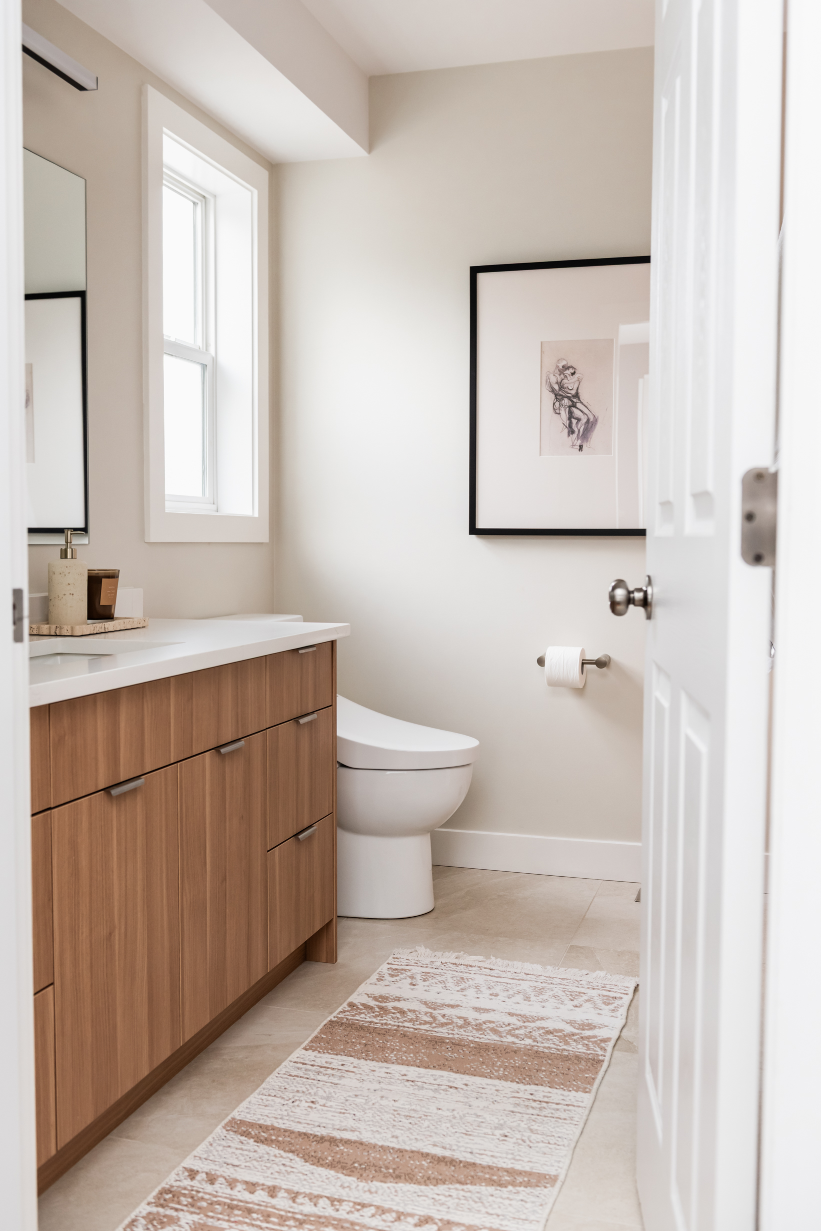 Ensuite bathroom featuring large tiled walk in shower with built in bench, oversized niche, and rainfall shower head.