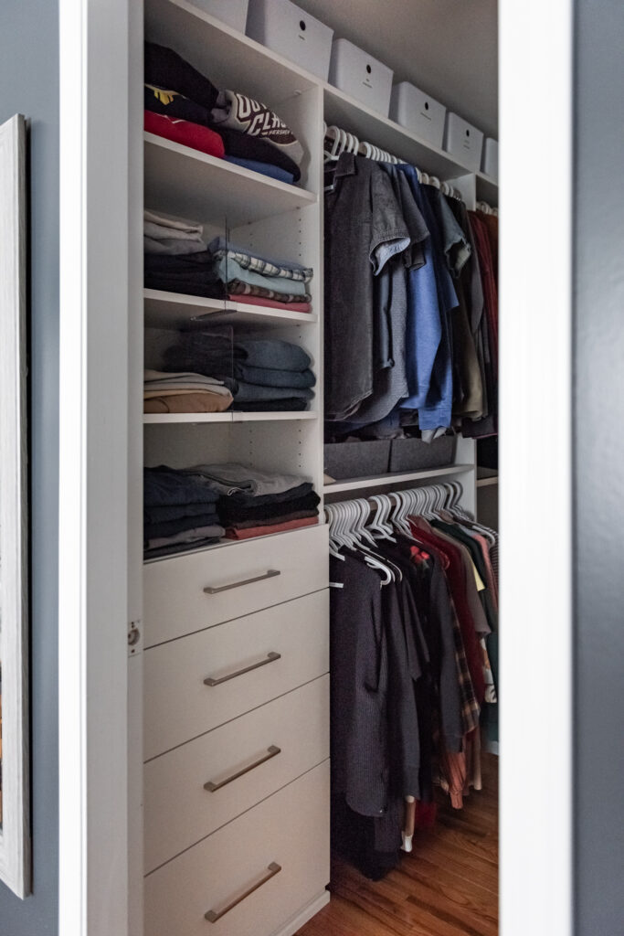 Custom walk in closet with built in storage zones for hanging clothes, folded items, and accessories.
