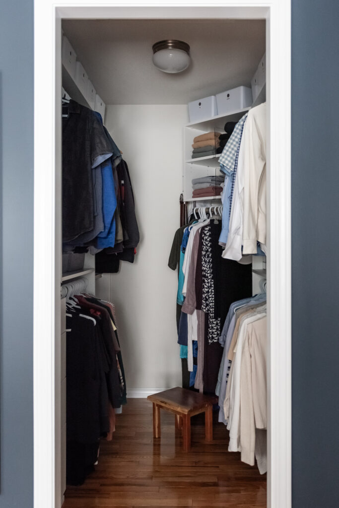 Custom walk in closet with built in storage zones for hanging clothes, folded items, and accessories.