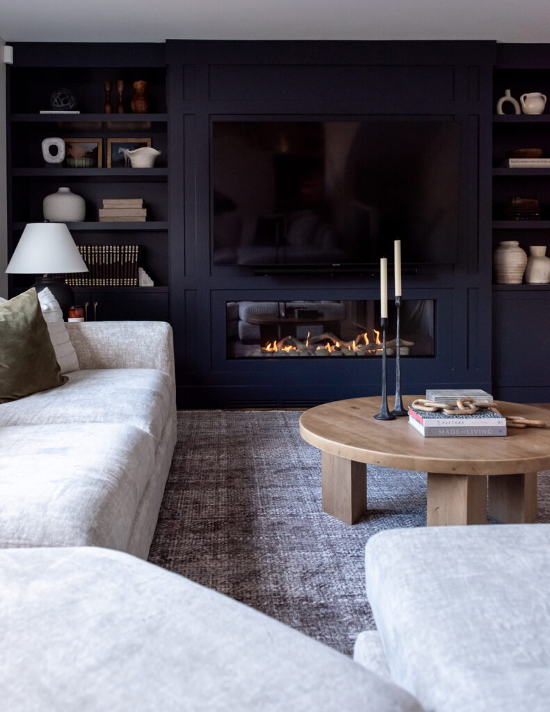 After photo of modern living room with linear fireplace and custom built-in cabinetry