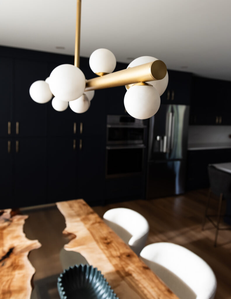 Custom navy pantry wall with floor-to-ceiling cabinetry for high-function family kitchen storage