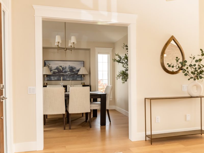 Transitional Dining room off entry, warm white