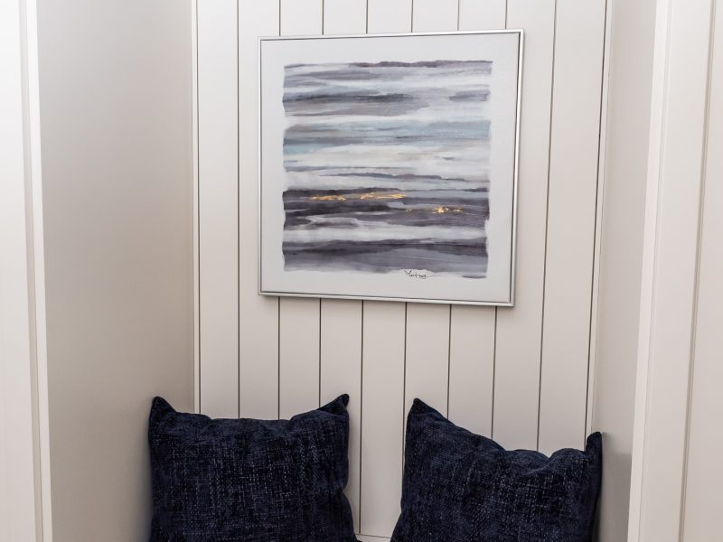 Cream mudroom cabinetry shiplap seating nook