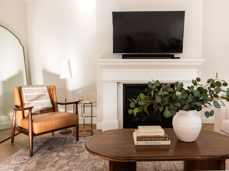 transitional living room cast stone fireplace, floor mirror