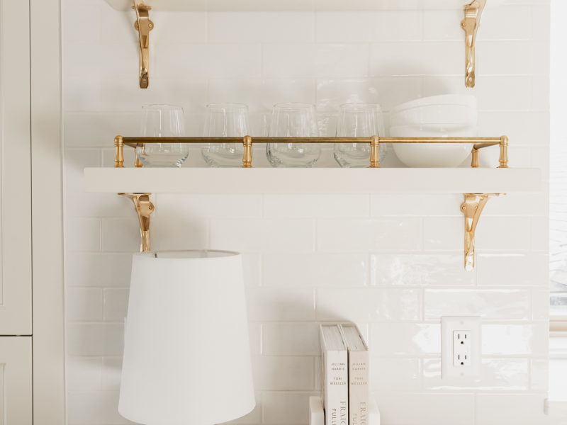 traditional brass shelves cream kitchen subway tile