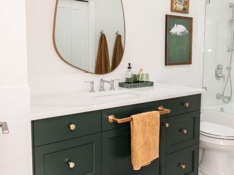 kids bath, boys bathroom, green vanity, irregular mirror, subway tile halfwall